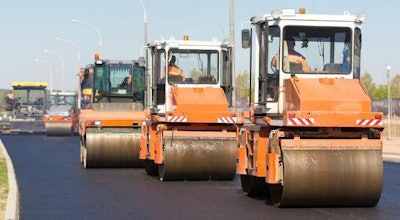 Steamrollers driving down the road