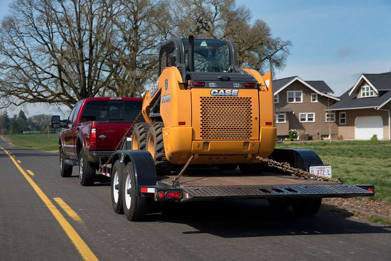 Towing Landoll LT1220 with Case skid-steer is easy work for 2015 F-350, which has a conventional tow rating of 14,000 pounds when using a weight-distributing hitch.