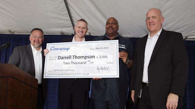 Con-way Freight executives, Darrin Black, service center manager, left, Greg Lehmkuhl, President, center left, and Dean Powers, director of operations, right, present a check to driver Darrell Thompson for driving 3 million accident free miles at the company's service center in Plainfield, Ind., Tuesday, May 19, 2015. (AJ Mast/AP Images for Con-way Freight)