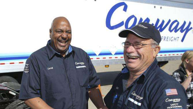 Con-way Freight driver Darrell Thompson, left, is congratulated by fellow driver Gary Felton on driving 3 million accident free miles at the company's service center in Plainfield, Ind., Tuesday, May 19, 2015. Felton, a long time friend of Thompson, is also a 2 million mile accident free driver. (AJ Mast/AP Images for Con-way Freight)