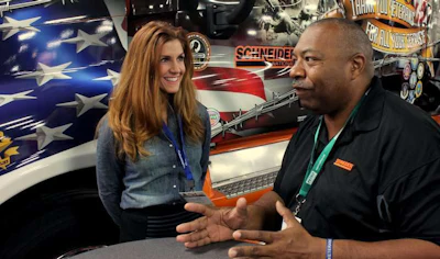 Randy Twine chats with a visitor the Schneider booth