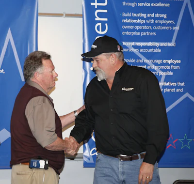 TAT Board President Mark Brown, left, congratulates Kevin Kimmel on his award.