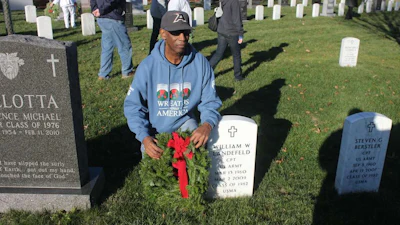 Randy Scott lays a wreath on a grave at West Point