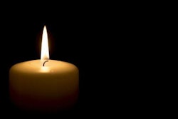 Lit candle in the dark