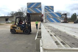 Sheetrock is unloaded from Mechigian's flatbed truck. (Photo: Deanne Winslett)