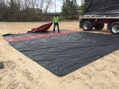 Mechigian lays the tarp out flat so she can fold it. (Photo: Deanne Winslett)