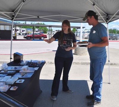 Helen Van Dam, director of the Freedom Drivers Project, offers Truckers Against Trafficking information to a Boyd Brothers employee.