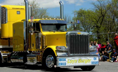 Yellow big rig show truck in a parade