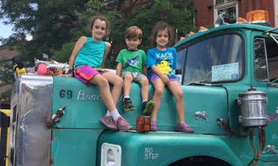 Aubrey, Charlie and Teagan Enk had the best seat in the house atop this 1976 Brockway H762.
