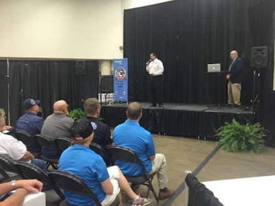 Eric Flick (on stage, left), of America's Road Team, speaks during the Trucking's Top Rookie ceremony at the Great American Trucking Show.