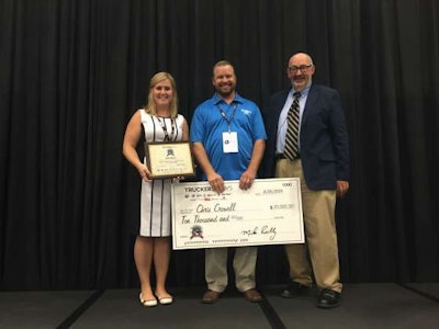 2016 Trucking's Top Rookie award winner Chris Crowell stands for a picture with his award check. Joining him are Marli Riggs (left) of Truckload Carriers Association and Truckers News Editor David Hollis (right).