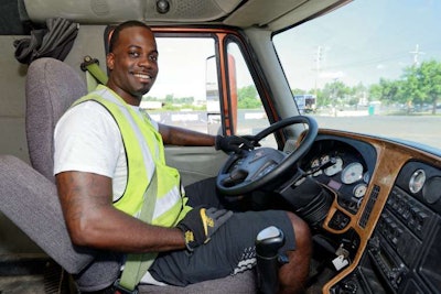 Gary Thompson, a driver in the college’s training program, poses for a picture in one of the training rigs. (Image Courtesy of WorkForce Solutions Group)