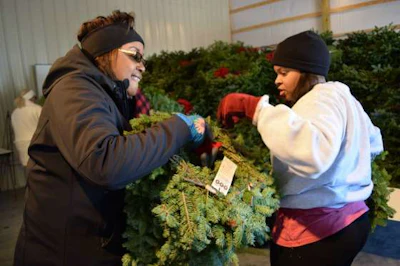 Volunteers work to unbox wreaths at Alabama National Cemetery.