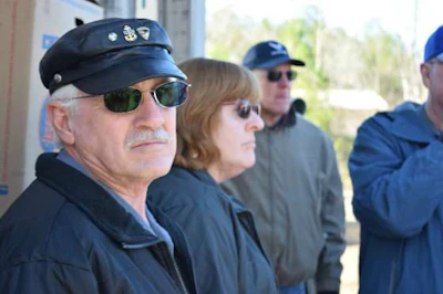 Alexis Pohl, center, speaks to Wreaths Across America volunteers at Alabama National Cemetery.