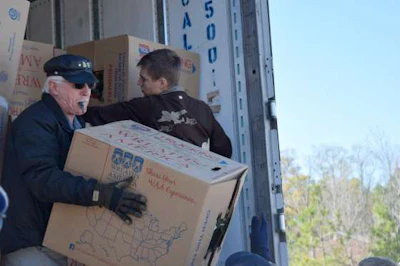 Volunteers unload boxes of wreaths at Alabama National Cemetery.
