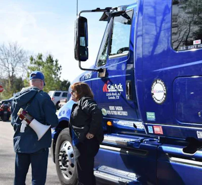 Alexis Pohl, a CalArk driver, speaks with a WAA organizer beside her truck.