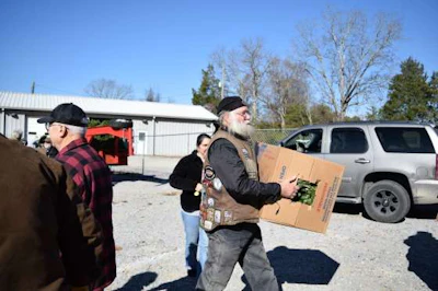 Volunteers carry boxes of remembrance wreaths off the truck at Alabama National Cemetery.