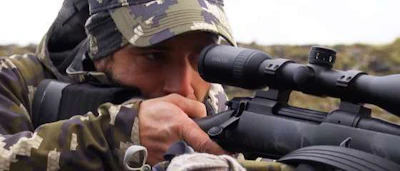 A hunter looks through his scope on Boundless Hunting.