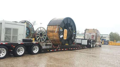 De La Rosa's truck gets loaded with an oversize load.