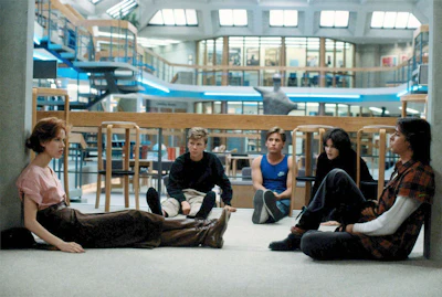 Members of the same detention class sit in a circle in a scene from The Breakfast Club. (Image Courtesy of HBO Now/Universal Pictures)
