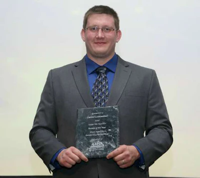 Daniel Lobbestael with his Rookie of the Year award at a formal ceremony by the American Moving & Storage Association. (Image Courtesy of AMSA)