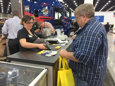 Attendees have their badges scanned for a free Team Run Smart hat.