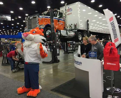 A tiger mascot greets attendees next to the BFGoodrich booth.