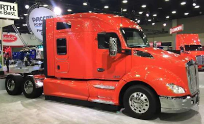 A bright orange, newer model Kenworth on display at MATS.