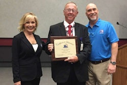 Driver Gary Killian, center, is recognized as an Outstanding Trucker Buddy at the Mid-America Trucking Show by Gloria Clements, left, Trucker Buddy’s director of development, and Randy Schwartzenburg, right, Trucker Buddy’s executive director.