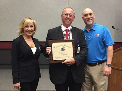 Driver Gary Killian, center, is recognized as an Outstanding Trucker Buddy at the Mid-America Trucking Show by Gloria Clements, left, Trucker Buddy’s director of development, and Randy Schwartzenburg, right, Trucker Buddy’s executive director.