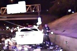 Still from dash cam shows Nevada Highway Patrol trooper dodging cans and bottles of beer on I-15.