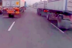 Would you ride a motorcycle between those two trucks?