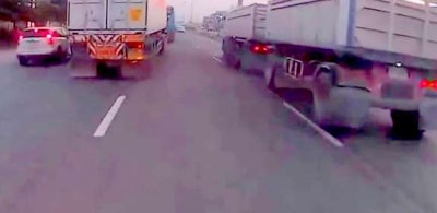 Would you ride a motorcycle between those two trucks?