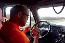 Driver in Starsky Robotics autonomous truck enjoying a snak