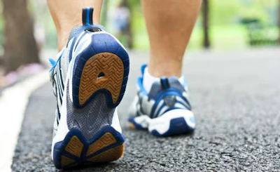 person walking in tennis shoes