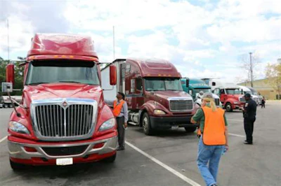 At a previous event, agents inspect trucks. (Image Courtesy of Alabama Trucking Association)