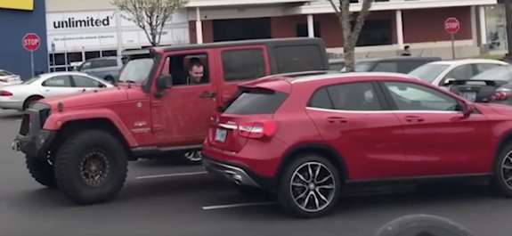 Jeep parked next to a car