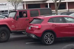 Jeep parked next to a car