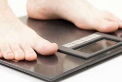 Trucker standing on a weight scale