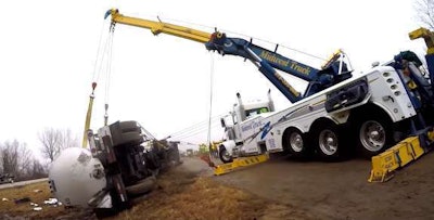 Midwest Truck crew rights a rolled over tanker.