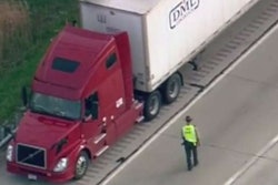 Illinois State Police investigate near the truck in which the driver was shot and killed Friday on I-88 west of Chicago.