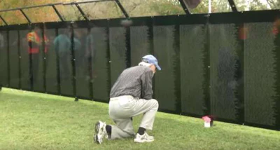 Man looking at the Vietnam Memorial Wall