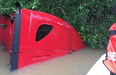 Submerged cab of tractor-trailer swept away in Arkansas flooding. (Jackson County Sheriff’s photo)