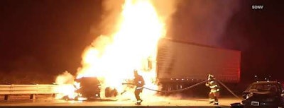 Firefighters work to extinguish a tractor-trailer fire in San Diego