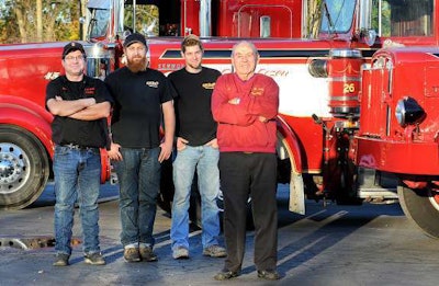 Richard Smith Sr. (right) whose father founded the family trucking business in Plumstaedville, is retiring and officially handing the business down to his son, Richard Jr (left), and grandsons, Robby and Kevin. (Photo by Art Gentile/The Intelligencer)