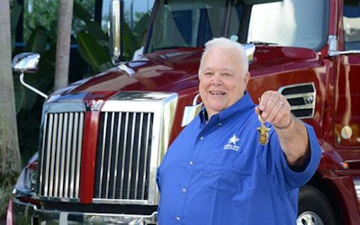 Landstar driver Dickie Penrod with the 2017 Western Star 5700XE tractor he won