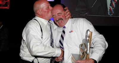 FedEx Express driver Roland Bolduc (right) receives a congratulatory kiss from colleague Scott Mugno after being named the 2017 Bendix Grand Champion at the 2017 National Truck Driving Championships and Step Van Driving Championships in Orlando, Florida. (Photo by John Sommers II)
