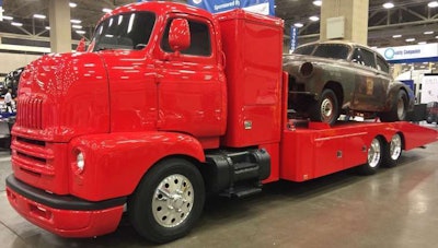 A bright red 1947 International COE with a GM 454 V8 engine on display at the American Truck Historical Society at GATS. It has an automatic transmission and motorhome chassis. Bill Robinson, from Waco, Texas, owns the truck.
