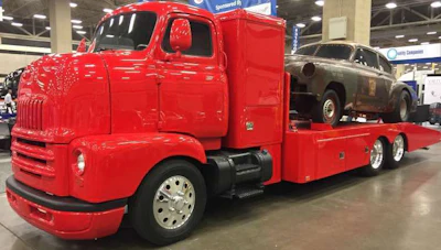 A bright red 1947 International COE with a GM 454 V8 engine on display at the American Truck Historical Society at GATS. It has an automatic transmission and motorhome chassis. Bill Robinson, from Waco, Texas, owns the truck.