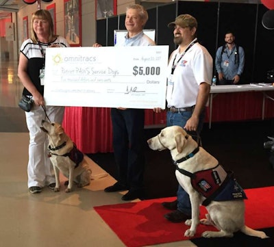 Omnitracs presented Patriot PAWS Service Dogs with a $5,000 donation at the GATS Red Eye Radio...